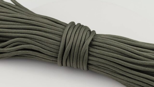 Olive-colored paracord cord. A skein of lace.
