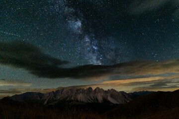 Aerial view of Dolomites mountain landscape under blissful Milky way in sky