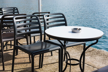 Modern restaurant terrace. Outdoor restaurant at the beach with pair of chair. Table setting at the beach restaurant