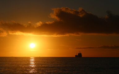 Photos of an amazing sunset at sea with ships - 676910499