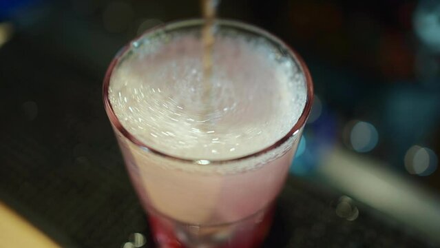 bartender prepare alcohol cocktail drink with red berry liquor, vodka and ice
