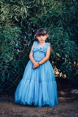 Fototapeta premium child in a blue dress on the beach in cyprus 