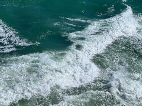Sea stormy waves with splashes and foam.