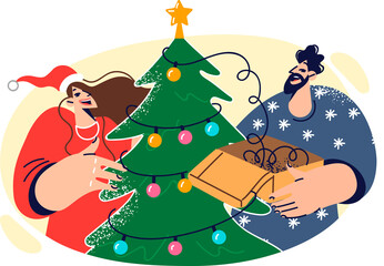 Happy man and woman decorate christmas tree, hanging garland with colorful lights