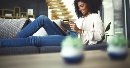 Credit card, tablet and woman on a sofa with ecommerce, sale or bank, loan and payment in her home. Digital, app and female person in a living room with online shopping, code or password for sign up