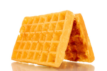 Two freshly baked aromatic waffles, macro, isolated on white background.