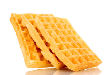 Three freshly baked aromatic waffles, macro, isolated on white background.