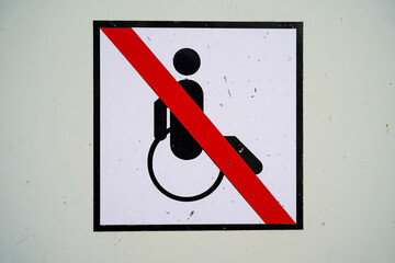 disability sign with a crossed out wheelchair. Universal accessibility conceptual pictogram. No...