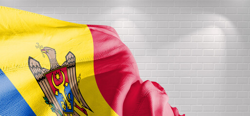 Moldova national flag cloth fabric waving on beautiful light Background.