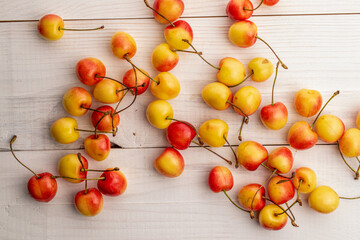 Several sweet cherry berries  on a wooden table, macro, top view.