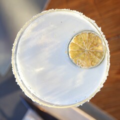 Top view of a cocktail with a lemon slice and salt