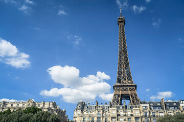 A Haussmann-style building (flat) with the Eiffel Tower (Tour Eiffel) in the background in Paris,...