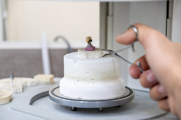Crowns oven with crown on gypsum holder with humans to prevent heat burns using holder
