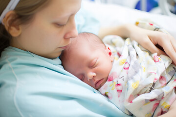 Unconditional Love: A Mother Embracing Her Precious Newborn