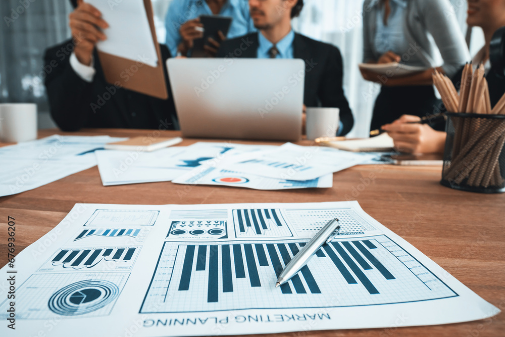 Aufkleber piles of analyzed financial data dashboard on meeting table with background of business people analy