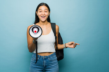 Attractive woman studying college using a megaphone