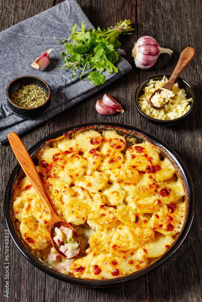 Poster au gratin potatoes with diced ham and green peas