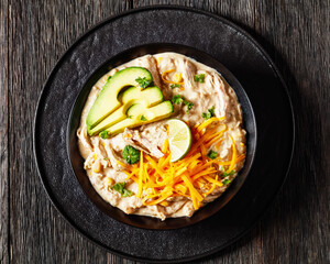 white chicken chili with cheese, avocado in bowl