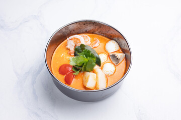 Seafood and herb soup. Close up