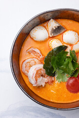 Seafood and herb soup. Close up