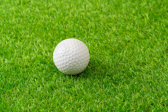 Sports, hockey ball on astro turf closeup with space for marketing or advertising outdoor.