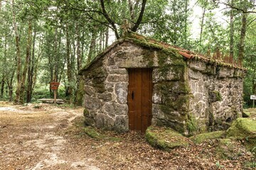 Fototapeta na wymiar Small stone house covered with moss