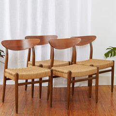 Set of four vintage minimalist cord chairs.  Elegant Mid-Century Modern design. Interior photograph...