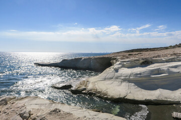 Coastal white stones against the background of the sea.