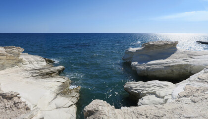 Coastal white stones against the background of the sea.