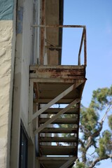 Vertical low-angle shot of rusted stairs leading upwards