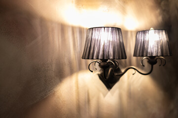 Sconce hanging on the wall with incandescent lamps turned on