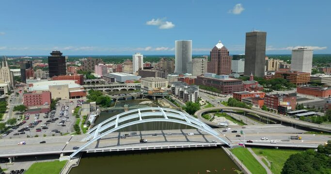 Rochester city downtown with cars driving on Frederick Douglass Susan B. Anthony Memorial Bridge over Genesee River in upstate New York. Urban architecture in the USA