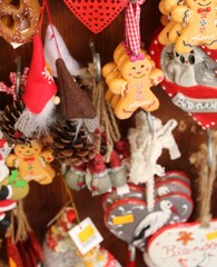 Vertical closeup shot of colorful Christmas toys hanging on a wooden board