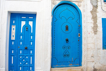 Narrow streets of old town medina in Sousse, Tunisia. Traditional Tunisian blue doors