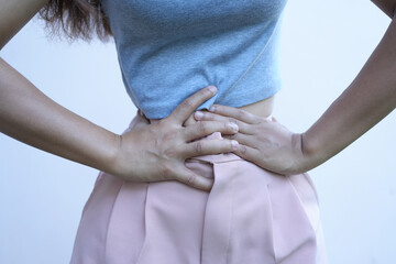 Asian woman lying with stomach ache From irregular menstruation