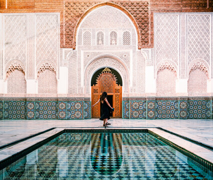 Marrakech, Marocco: tourist exploring the interior of Ben Youssef Madrasa, ancient Islamic school founded in the 14th century