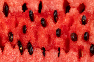 a large number of black seeds in a red ripe watermelon