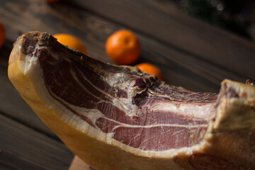 Top view of whole Serrano ham and oranges