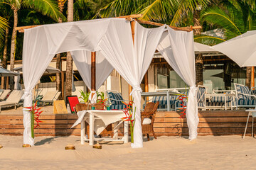 Luxury resort hotel outdoor restaurant on the beach, tropical island cafe, table ready for serving....