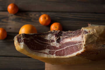 Top view of whole Serrano ham and oranges