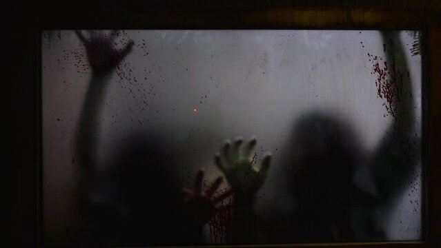 Blurred hands of kidnapped people scratch bloodied window. Chilling spectacle of kidnapped people desperation. Concept of visual horror as kidnapped people claw for escape, grim scene of captivity.