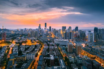Foto op Aluminium Aerial view of the stunning city skyline illuminated by the setting sun in Dalian, China © Wirestock