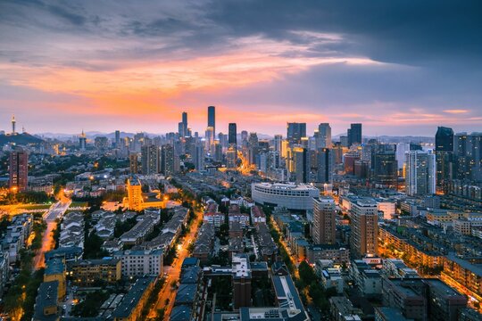 Aerial view of the stunning city skyline illuminated by the setting sun in Dalian, China