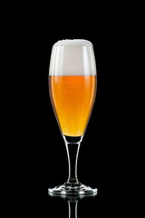transparent and cold glass of refreshing beer on a black background