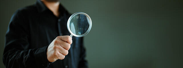 Man use magnifying glass studio background. Use hand lens glass magnifier search for best option,...