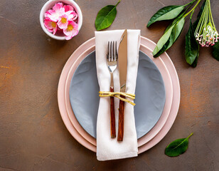 Dinner plate setting with cutlery and napkin. Top view