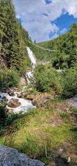 Obraz premium hike to Stuibenfall highest waterfall in Tyrol is the 159-meter-high Stuibenfall. It dazzles passers-by with its enormous water amount. An exciting point during the trail is an 80-meter-long steel su