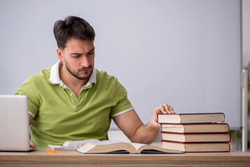 Young male student sitting in front of whiteboard