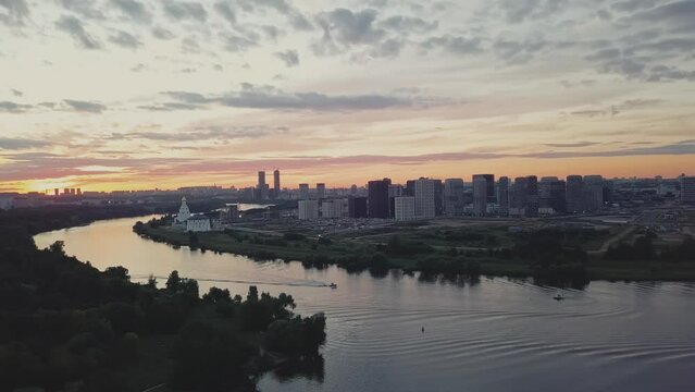 A green district of city with parks, river and high-rise residential buildings.