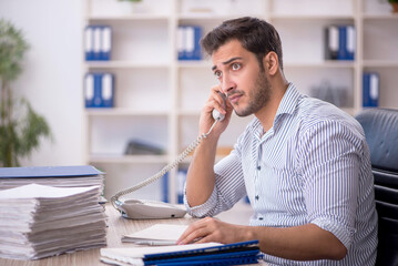 Young male employee working in the office